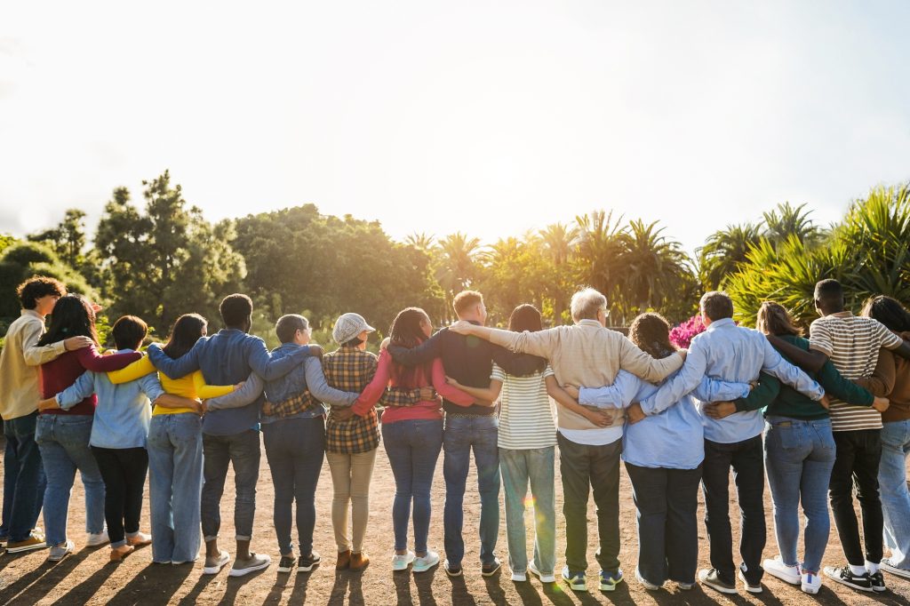 Group of multigenerational people hugging each others - Support, multiracial and diversity concept Group of multigenerational people hugging each others - Support, multiracial and diversity concept